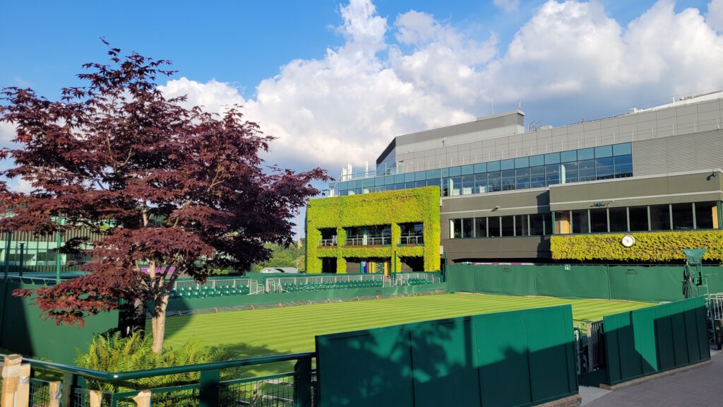 Tennis court with stadium in background