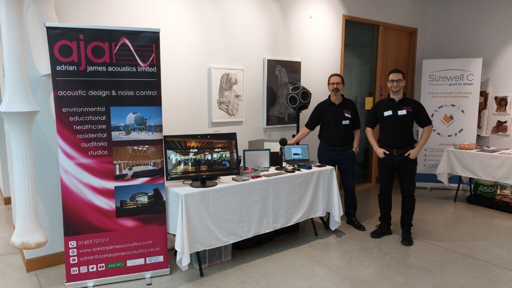 2 men standing at an exhibition table