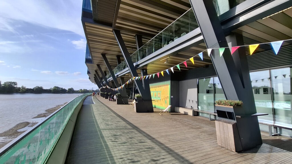 Walkway outside Fulham Pier building next to a river